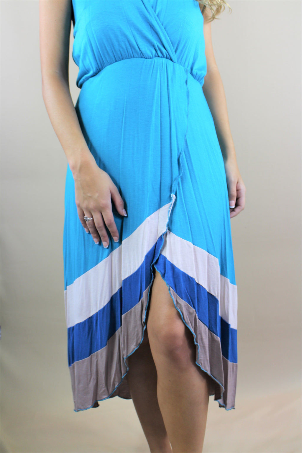 This open back halter dress comes in a blue stripe design and is constructed of 92% rayon and 8% spandex. The flowy design is perfect for your boutique.